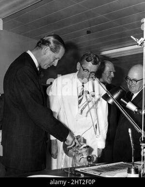 Prince Philip, the Duke of Edinburgh, risks a finger as he examines a realistically mounted set of teeth during his tour of the Dental School and Hospital at Heath, Cardiff. Detailed explanation is supplied by Dr J D Eccles, senior lecturer in conservative dentistry. 7th July 1966. Stock Photo