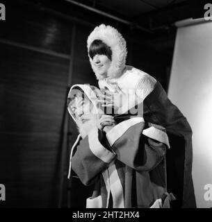 Christmas preparations for Ready Steady Go! at Rediffusion - British rock group The Animals with television presenter Cathy McGowan dressed in Father Christmas outfits.Here she is pictured with lead singer Eric Burdon. 1st December 1965. Stock Photo