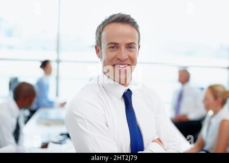 One day hell be CEO. Handsome young male executive in his workplace. Stock Photo
