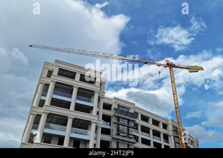 Industrial crane working on construction building site,workplace machine Stock Photo