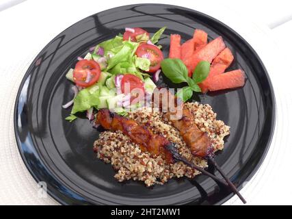 Grilled chicken skewers with quinoa Stock Photo
