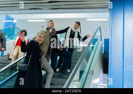 Group of multiracial busniess people are going up on the escalator Stock Photo
