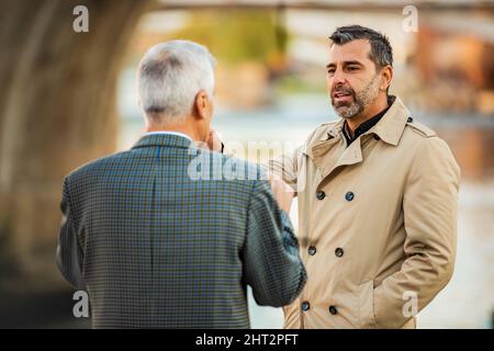 Two amazing senior businessmen are talking to each other, close up Stock Photo