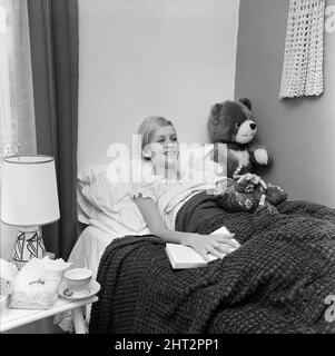 Twiggy, model aged 17 years old, was to be a guest of honour at Women of the Year luncheon at the Savoy Hotel, but was instead confined to bed, on doctors orders, because of a nervous rash on her hands and feet, pictured at home in Neasden, London, 10th October 1966. Stock Photo