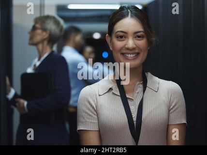 Brimming with excitement for all my tomorrows. Portrait of a young beautiful woman working in server room. Stock Photo