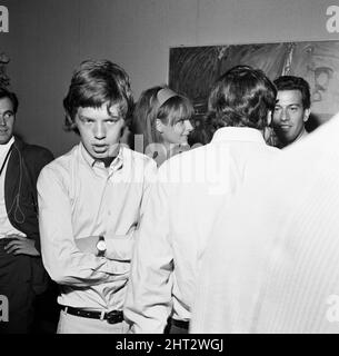 Mick Jagger, lead singer of the  Rolling Stones pop group, attending the wedding of photographer David Bailey and French actress Catherine Deneuve. 18th August 1965. Stock Photo