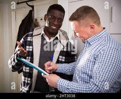 Smiling man participating in survey at home Stock Photo