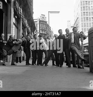 What a sight for TV crime series fans. Here pictured during a break in rehearsals for tonight's show at London's Prince of Wales Theatre are a team of TV cops. Putting the policeman's lock on each other are Z-Cars Inspector Barlow (Stratford Johns) with his colleagues Robert Keegan, James Brady, Brian Blessed, Frank Windsor, James Ellis, Colin Welland, Peter Byrne, Geoffrey Adams, Johnny Briggs, Michael McStay, Robert Raglan, Bruce Seaton and Rupert Davies. 28th March 1965. Stock Photo