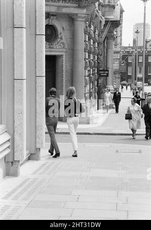 Life at the Top, 1965 film, on location filming around The Economist building in St James, London, SW1, Sunday 25th July 1965. The film stars Laurence Harvey, who reprises the role of Joe Lampton in a sequel to 1959 film Room at the Top.  Our picture shows ....  Terence Stamp and Jean Shrimpton, leaving, they had met with friend Laurence Harvey for a chat during a break in filming. Stock Photo