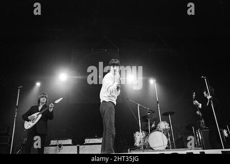 New Musical Express Poll Winners pop concert at Empire Pool Wembley, 1965.The Rolling Stones performing on stage during the concert. Left to right: Brian Jones, singer Mick Jagger, drummer Charlie Watts (mostly hidden) and Keith Richards. The Stones won awards for Best British R & B Group as well as Best New Disc Of The Year for their single (I Can't Get No) Satisfaction. 11th April 1965. Stock Photo