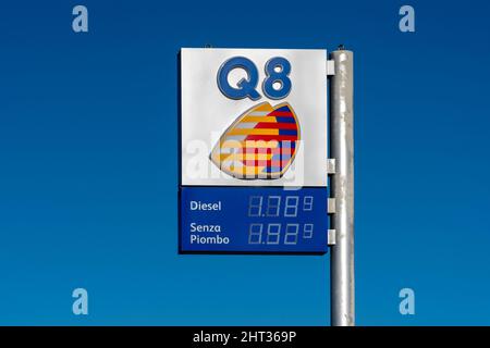 Fossano, Italy - February 26, 2022: Q8 logo sign with fuel Euro price display on gas station on blue sky, it is brand of Kuwait Petroleum Internationa Stock Photo