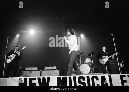 New Musical Express Poll Winners pop concert at Empire Pool Wembley, 1965.The Rolling Stones performing on stage during the concert. Left to right: Brian Jones, singer Mick Jagger, drummer Charlie Watts (mostly hidden) and Keith Richards. The Stones won awards for Best British R & B Group as well as Best New Disc Of The Year for their single (I Can't Get No) Satisfaction. 11th April 1965. Stock Photo