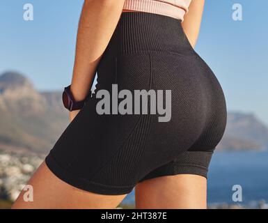 Its important to have the correct running gear. Closeup shot of an unrecognizable and athletic young woman in running shorts taking a break during her Stock Photo