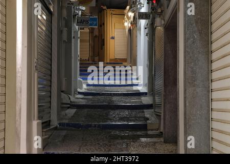 Santorini,  Greece - May 9, 2021 : An  empty alley with closed shops in the center of Fira Santorini Stock Photo