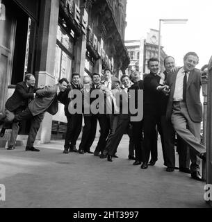 What a sight for TV crime series fans. Here pictured during a break in rehearsals for tonight's show at London's Prince of Wales Theatre are a team of TV cops. Putting the policeman's lock on each other are Z-Cars Inspector Barlow (Stratford Johns) with his colleagues Robert Keegan, James Brady, Brian Blessed, Frank Windsor, James Ellis, Colin Welland, Peter Byrne, Geoffrey Adams, Johnny Briggs, Michael McStay, Robert Raglan, Bruce Seaton and Rupert Davies. 28th March 1965. Stock Photo