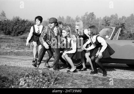 The filming of 'The Great St Trinian's Train Robbery' starring Portland Mason (James Mason's daughter) and George Cole as 'Flash' Harry. On location at Longmoor Army Camp, near Liss, Hampshire. 17th October 1965.The filming of 'The Great St Trinian's Train Robbery' starring Portland Mason (James Mason's daughter) and George Cole as 'Flash' Harry. On location at Longmoor Army Camp, near Liss, Hampshire. 17th October 1965. Stock Photo