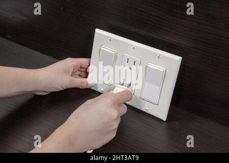 Checking electrical outlet connecting the electrical plug before installing it in a junction box on the wall Stock Photo