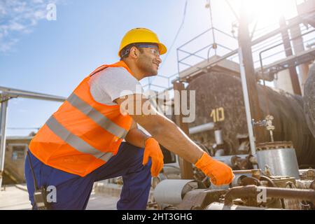 Photo of happy multiethnic worker in plant Stock Photo