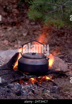 cowboy coffee pot boiling over open campfire burn steam cook