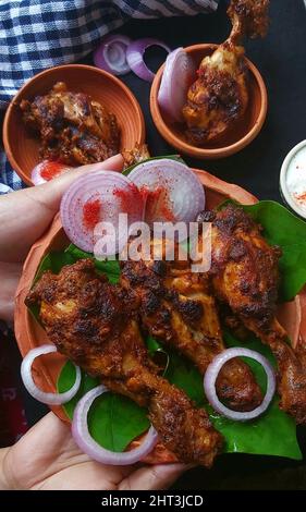 Vertical shot of traditional Indian dish Bhatti Ka Murgh Stock Photo