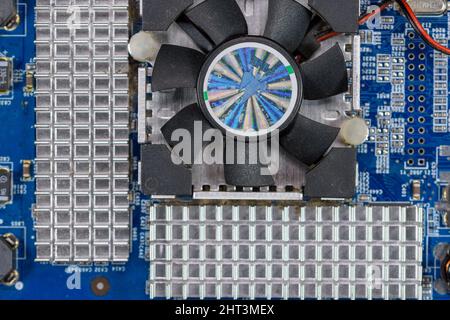 Close up of the heat sinks and fan of an NVidia computer video card. Stock Photo