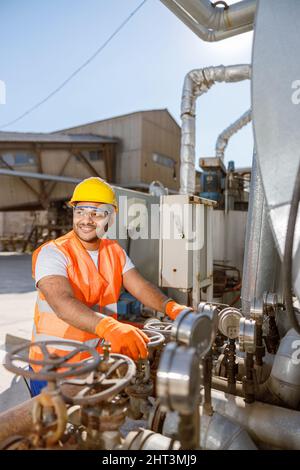 Young construction industry worker is working outdoors Stock Photo