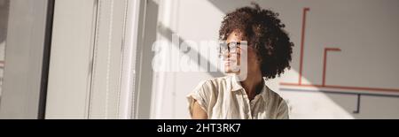Pretty multiethnic lady sitting at work desk in the office Stock Photo