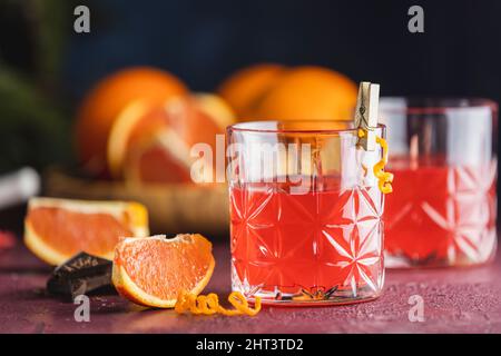 Two glasses of chocolate red orange negroni, an italian cocktail, an aperitif, first mixed in Firenze, Italy, in 1919, alcoholic bitter cocktail serve Stock Photo