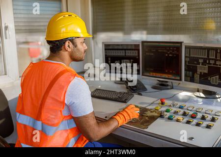 Young multiethnic operator working at concrete plant Stock Photo