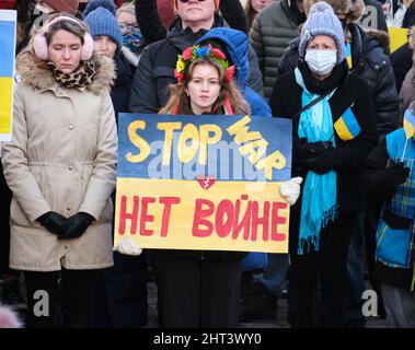 Halifax, Nova Scotia, Canada. February 26th, 2022. Protester with Stop War (English) No War (Ukrainian) sign part of Crowd gathered in front of city hall to protest the War in Ukraine . the protest gathered locals demanding the end of the war in Ukraine, and withdrawal of invading Russian troops. Stock Photo