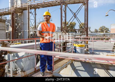 Worker with safety equipment working at heavy industry plant Stock Photo