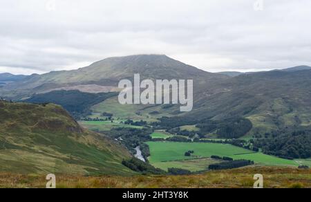 Meall Breac with cloud cover over the peak and the River Tummel flowing below towards Loch Rannoch, Glen Lyon, Scotland, United Kingdom Stock Photo