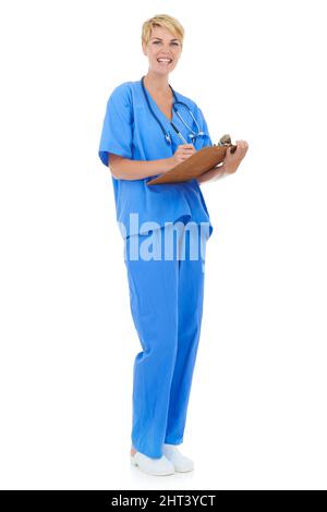 Keeping track of her daily schedule. A young female doctor holding a clipboard against a white background. Stock Photo