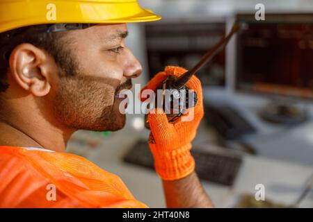 Young multiethnic operator working at construction plant Stock Photo