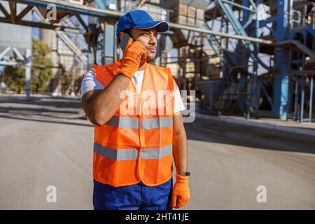 Photo of man working hard at construction industry plant Stock Photo