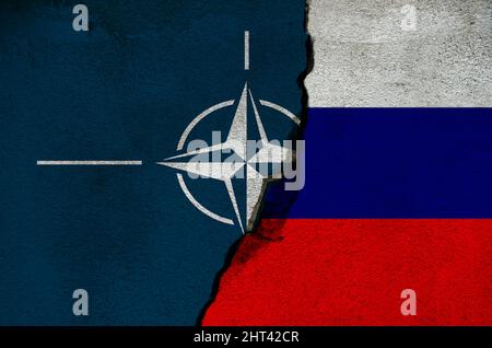 Nato and Russian flag on cracked wall. Diplomatic relations between Russia and Nato. War and peace concept. Stock Photo