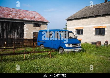 Closeup shot of the Polish FSO Lublin van dumped next to old building Stock Photo