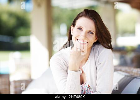 The sunlight and fresh air does wonders for me. Portrait of an attractive woman having a relaxing time outdoors. Stock Photo