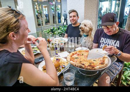 Bal Harbour Florida Bal Harbour Shops upscale luxury designer mall shopping dog pet Carpaccio Restaurant diners dining sharing table family Stock Photo