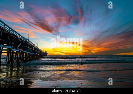 The sunset sky over the Pacific ocean and a pier in San Clemente, California, USA Stock Photo
