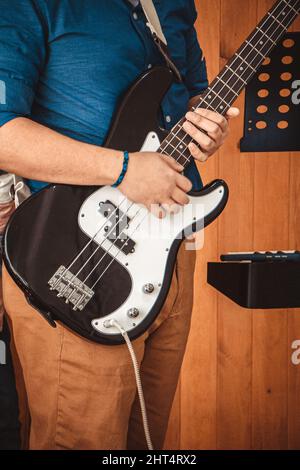 The male man with a electric white-black guitar in his hand Stock Photo