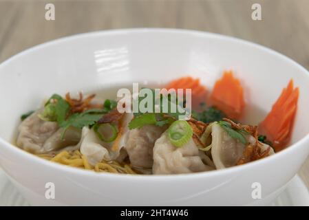 Hearty wonton noodles soup, served with hot broth, for a delicious Vietnamese meal. Stock Photo