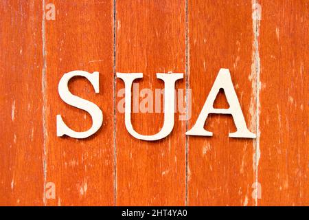 Alphabet letter in word SUA (Abbreviation of Single use account) on old red color wood plate background Stock Photo