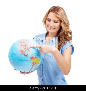Theres so much to explore - Travel Tourism. A pretty young woman pointing to the East Coast of North America on a world globe. Stock Photo