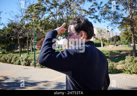 Closeup of a man covering his face from sunbeams Stock Photo