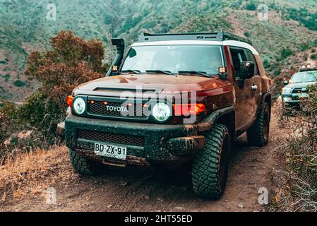 Red offroad SUV vehicle passing obstacles on an offroad course in Santiago, Chile Stock Photo