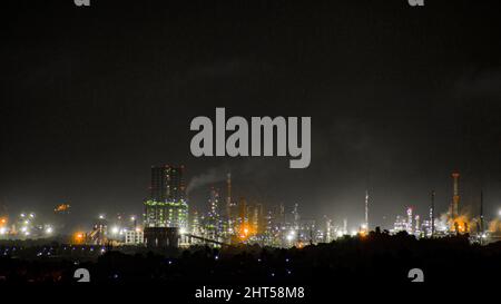 A picture of manglore city's industrial area in night. The smoke coming from the industrial exhaust can be seen. Stock Photo