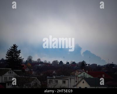 Kiev, Ukraine - February 27, 2020: Smoke from a fire at an oil depot in the city of Vasilkiv is clearly visible in Boryspil at a distance of about 40 km. Russian troops launched a missile attack on an oil depot on the outskirts of Vasilkiv. Due to the ongoing shelling, the firefighters were not able to start extinguishing the fire. Stock Photo