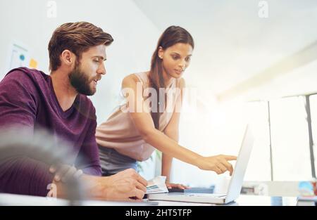 And this. Cropped shot of two young architects working on a laptop. Stock Photo