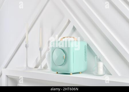 Mobile mini refrigerator on a shelf in living room, side view Stock Photo
